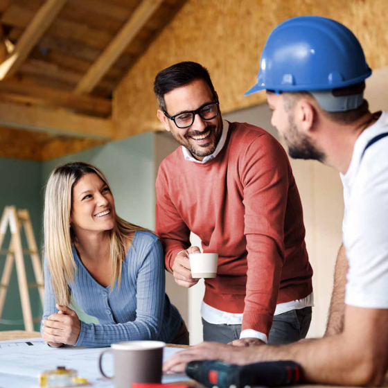 family-and-contractor-reviewing-blueprints